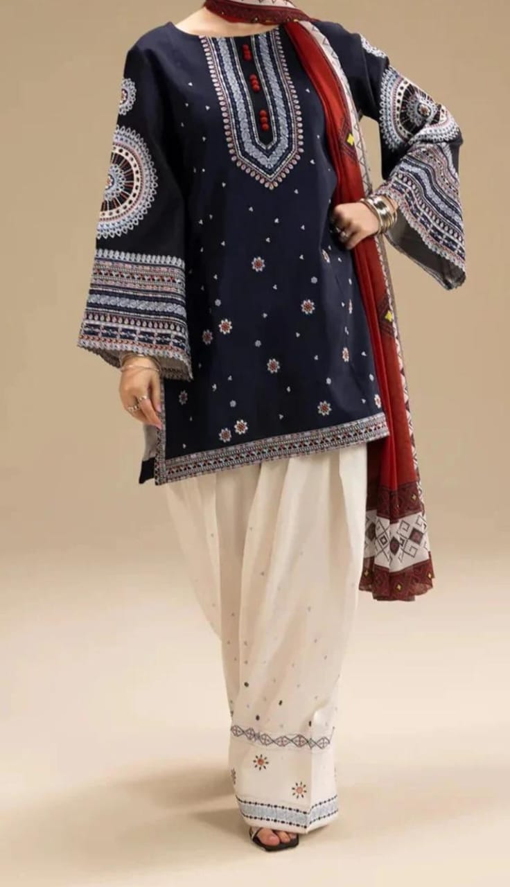 Traditional outfit with navy blue embroidered top and white pants on a beige background