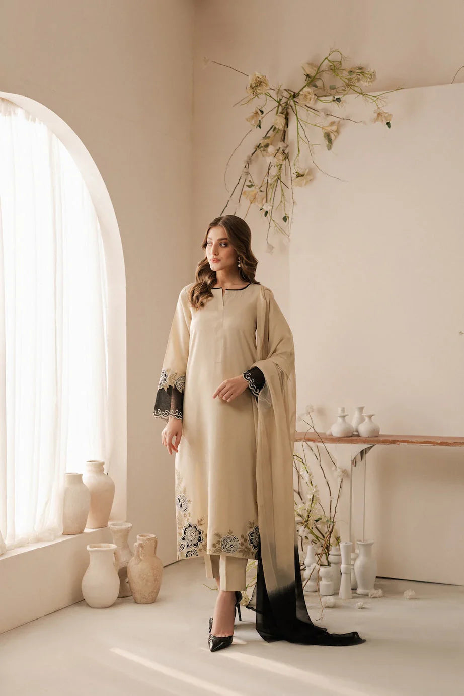 Elegant floral embroidery on beige Pakistani kurta