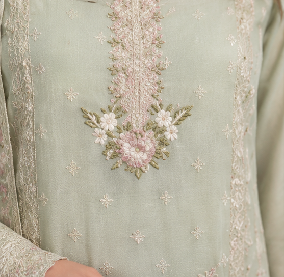 Close-up of a light green fabric with floral embroidery
