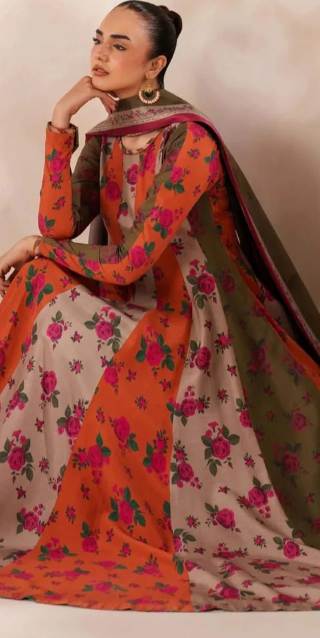 Woman wearing a traditional outfit with floral patterns in orange, pink, and beige.