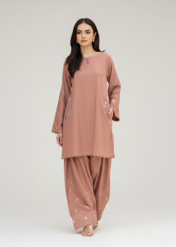 Woman wearing a matching brown kurta and palazzo set on a white background
