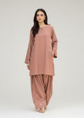 Woman wearing a matching brown kurta and palazzo set on a white background