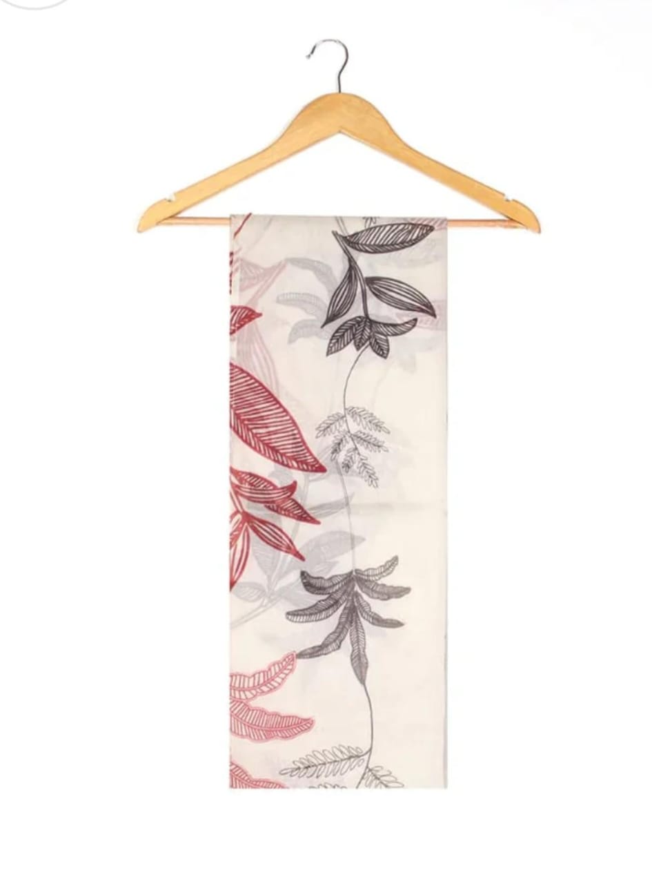 Scarf with leaf pattern on a wooden hanger against a white background