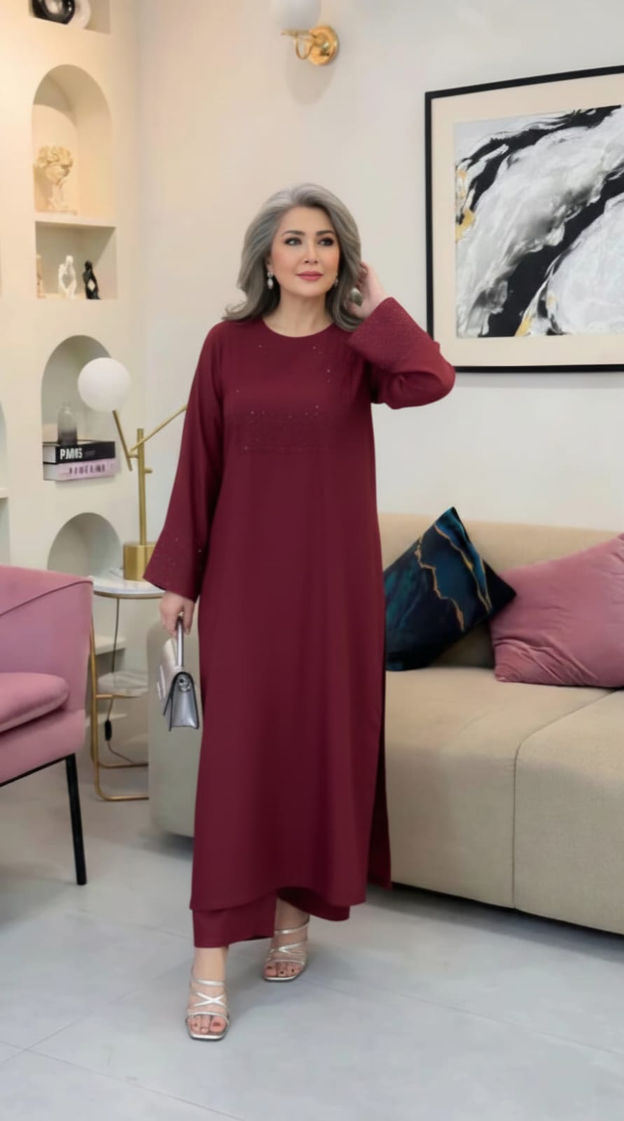 Woman in a burgundy dress standing in a living room.