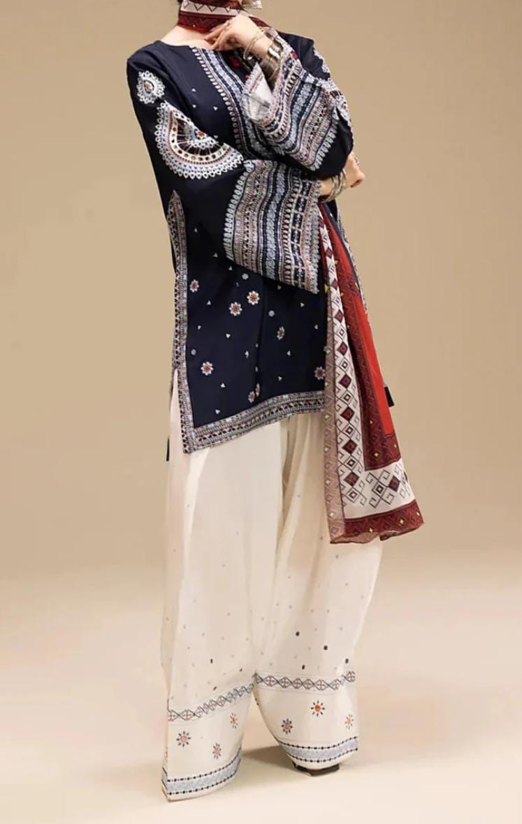 Traditional outfit with embroidered navy top and white pants on a beige background