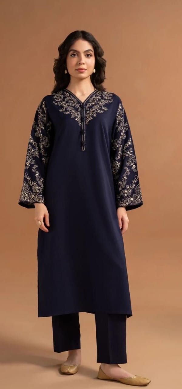 Woman wearing a navy blue kurta with floral patterns on a brown background
