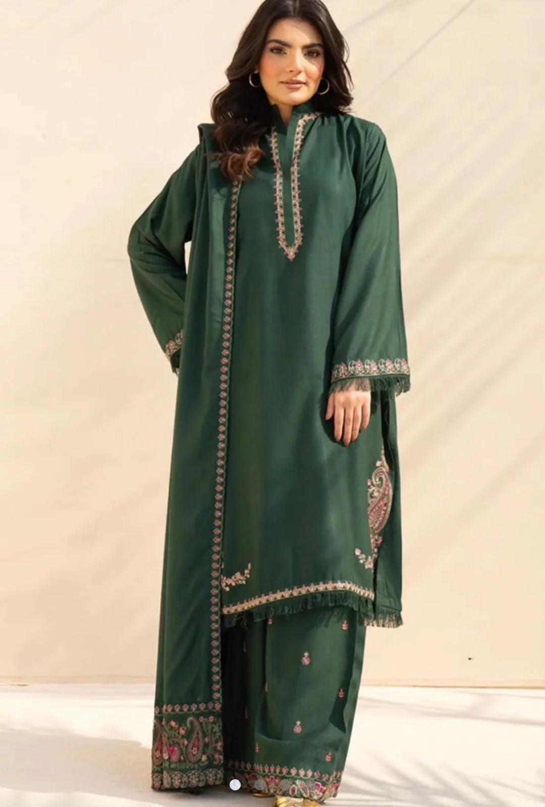 Green traditional outfit with intricate patterns on a plain background