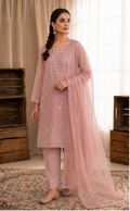 Woman wearing a pink traditional outfit with a matching dupatta in a neutral setting.