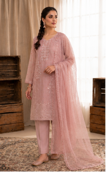 Woman wearing a pink traditional outfit with a matching dupatta in a neutral setting.