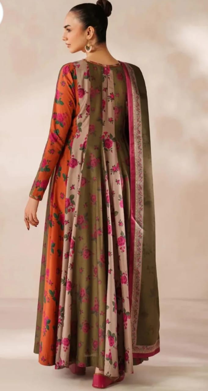 Woman wearing a long floral dress with a matching dupatta against a neutral background