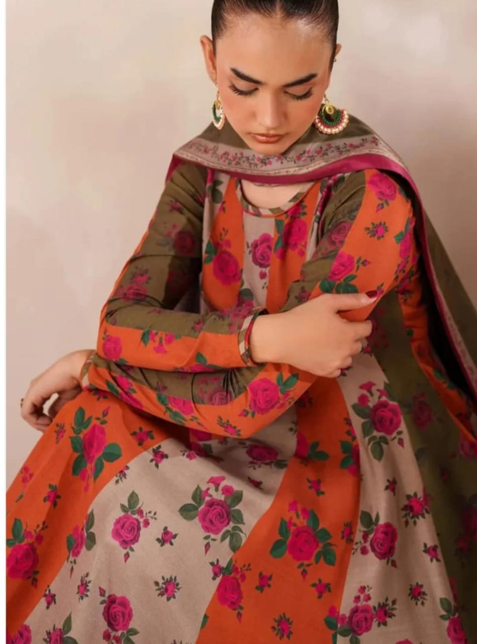 Woman wearing a floral traditional outfit with an orange and green pattern.