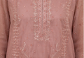 Pink embroidered garment with intricate patterns