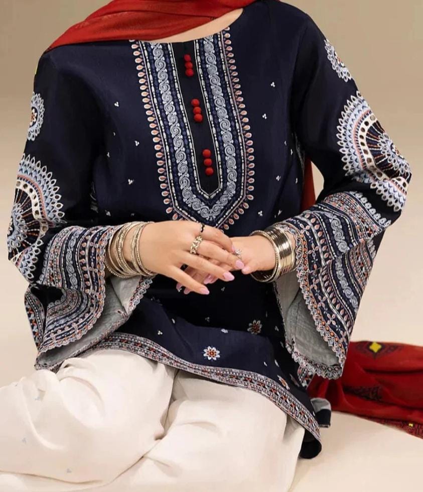 Navy blue embroidered top with white pants on a neutral background