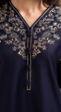 Navy blue garment with intricate gold embroidery on a blurred background